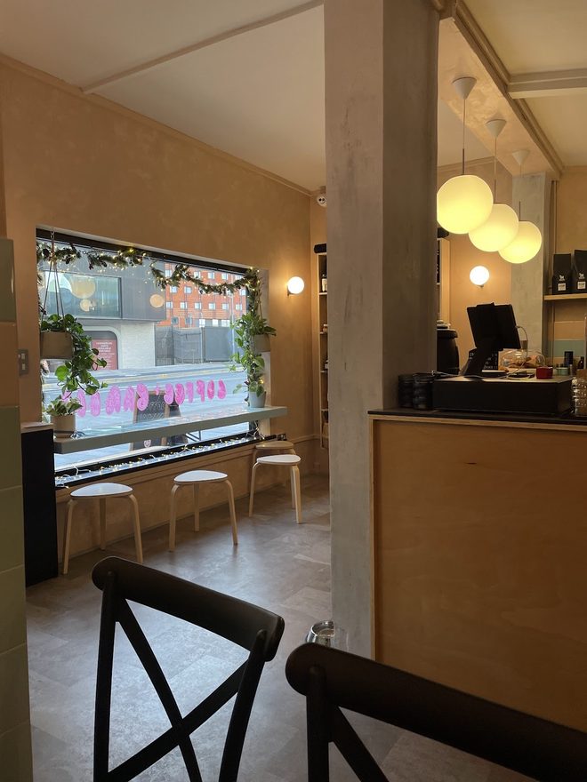 The window bench and stools inside the cafe