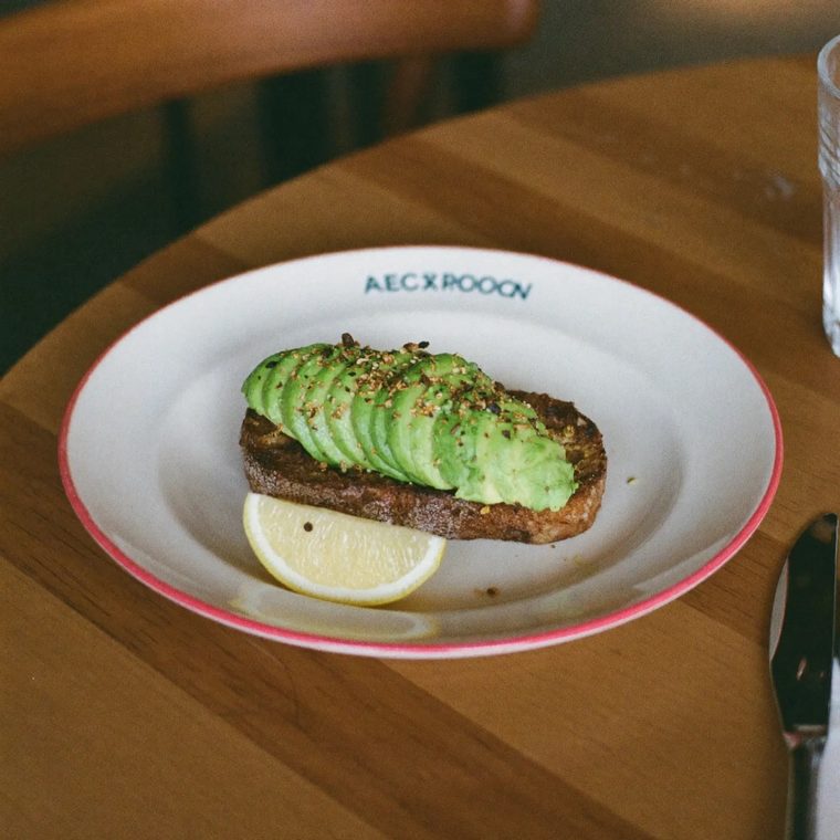 Avocado on toasted sourdough on a wooden table